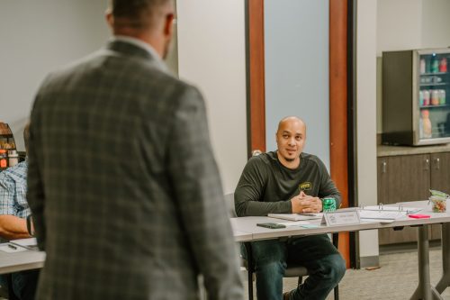 A Rmada United student talking with an instructor with a smile