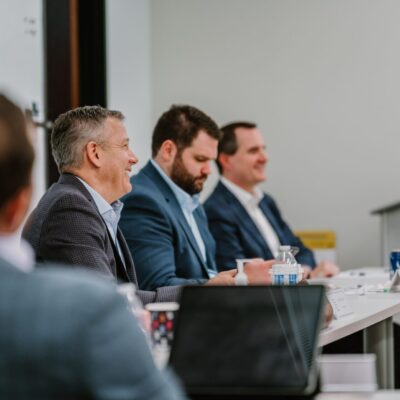 A line of Rmada United students listening to an instructor at a long table
